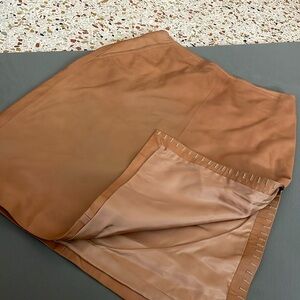 Leather skirt side slit.